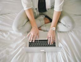 A woman writing on her laptop