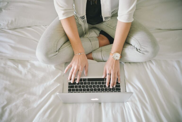 A woman writing on her laptop