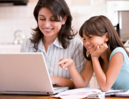 mothers in college showing their child their work