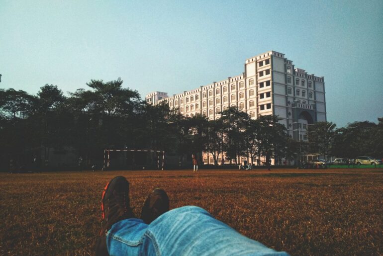Person relaxing about rolling admissions while looking at their campus