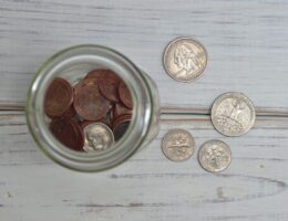 Loose change on a table and in a jar