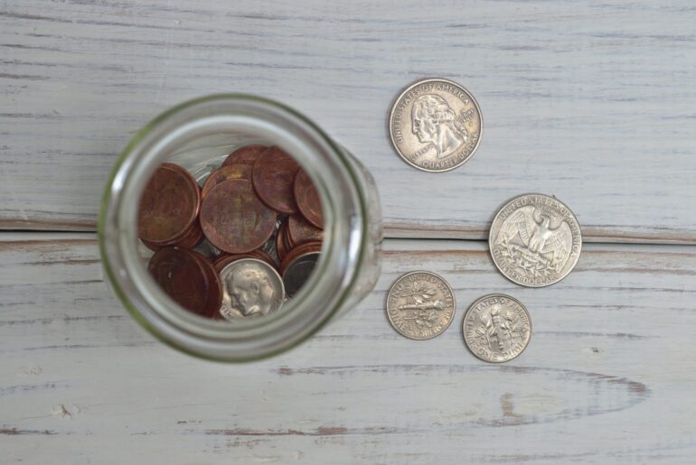 Loose change on a table and in a jar