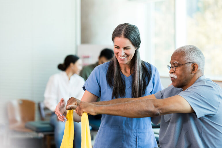 Therapist who went through occupational therapy college and now is working with an elder doing elastic band exercises