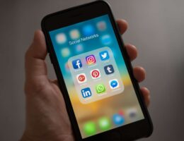 Someone holding a phone with social networks open