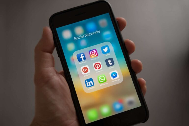 Someone holding a phone with social networks open