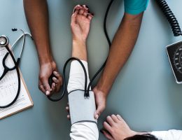 Nurse taking a patient's blood pressure.