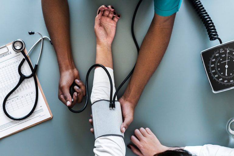 Nurse taking a patient's blood pressure.
