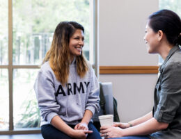 two female veterans connecting at a campus meeting