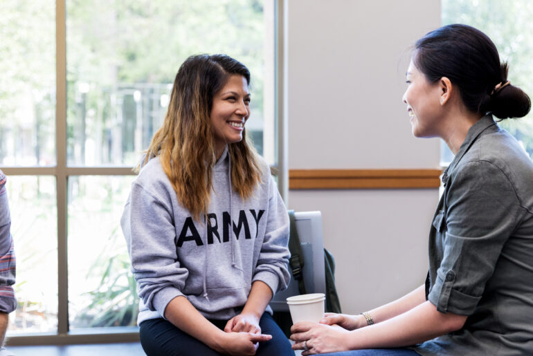 two female veterans connecting at a campus meeting