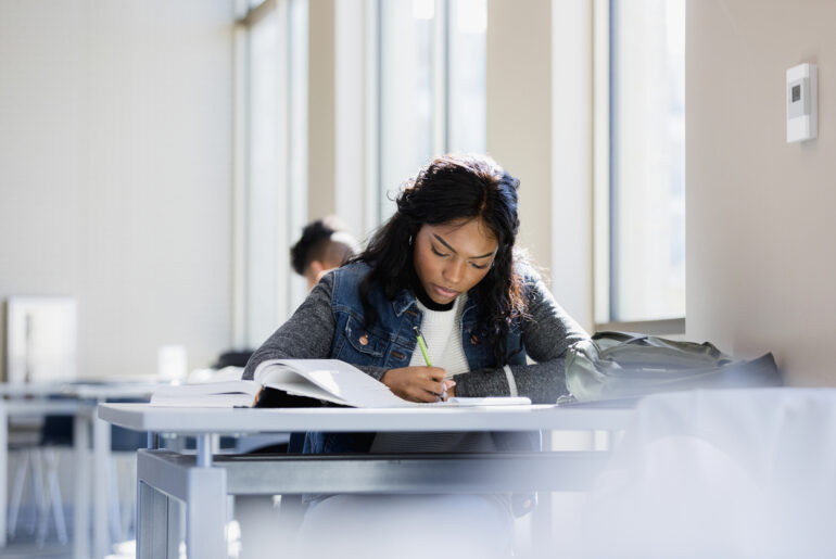 Student studying for the TACHS exam to ensure their success.