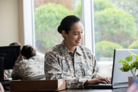 Female Student preparing for good Army ASVAB and AFOQT Scores with a laptop in front of her