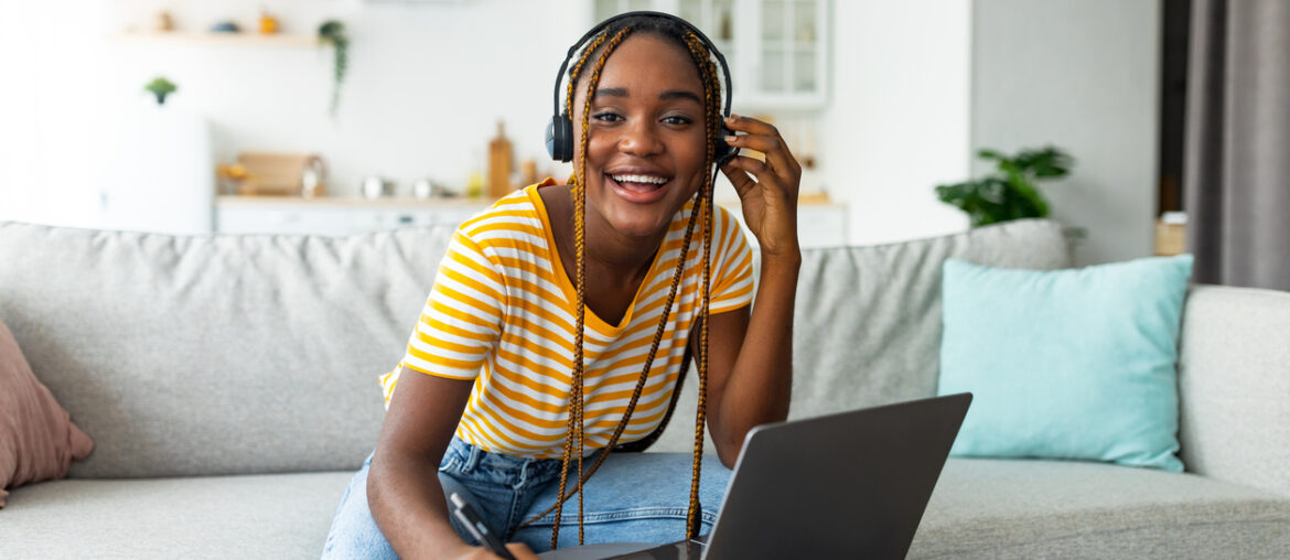 Young woman smiles as she learns how to write a good CLEP College Composition essay