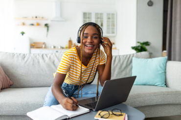 Young woman smiles as she learns how to write a good CLEP College Composition essay