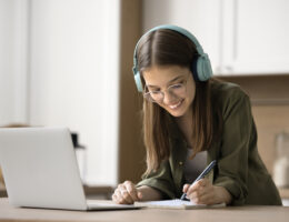 A girl tracking progress from her HSPT practice test scores to set goals