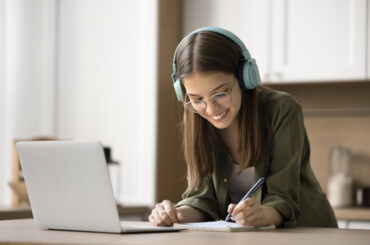 A girl tracking progress from her HSPT practice test scores to set goals