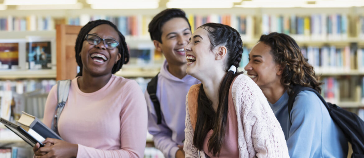 Four students studying CLT prep in a library