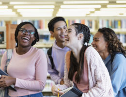 Four students studying CLT prep in a library