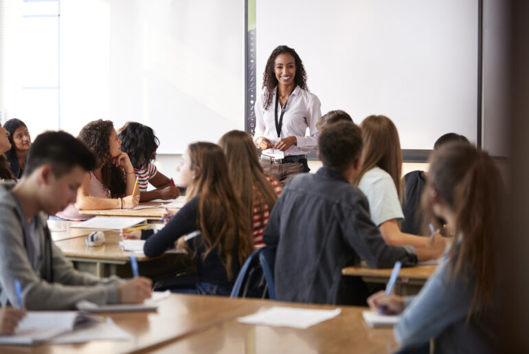 Inside an AP Classroom looking at teacher with her students