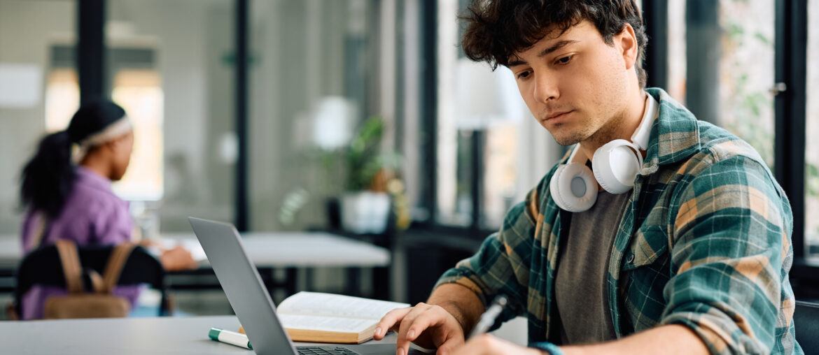 Young man studying for the SIFT test on his laptop