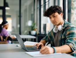 Young man studying for the SIFT test on his laptop