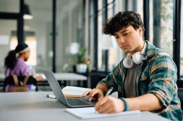 Young man studying for the SIFT test on his laptop