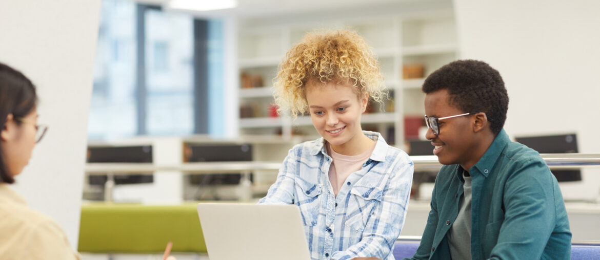 Students who are making student progress in their standardized test scores in a library through digital test prep