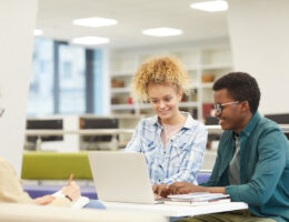 Students who are making student progress in their standardized test scores in a library through digital test prep
