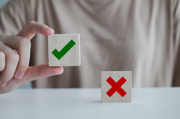 A student holding a block up to indicate clep credit being accepted at his school