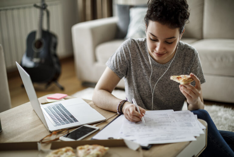 Busy student taking ACT practice test while eating