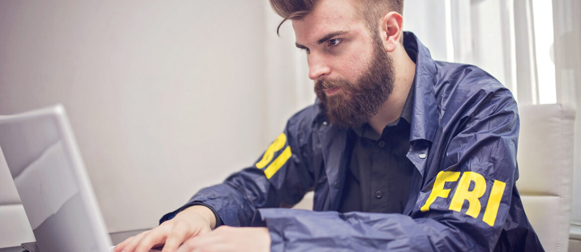 FBI student studying on a laptop for the FBI test