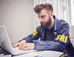 FBI student studying on a laptop for the FBI test