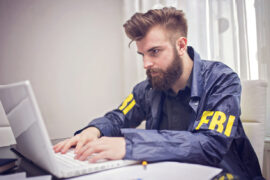FBI student studying on a laptop for the FBI test