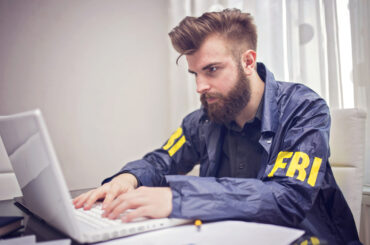 FBI student studying on a laptop for the FBI test