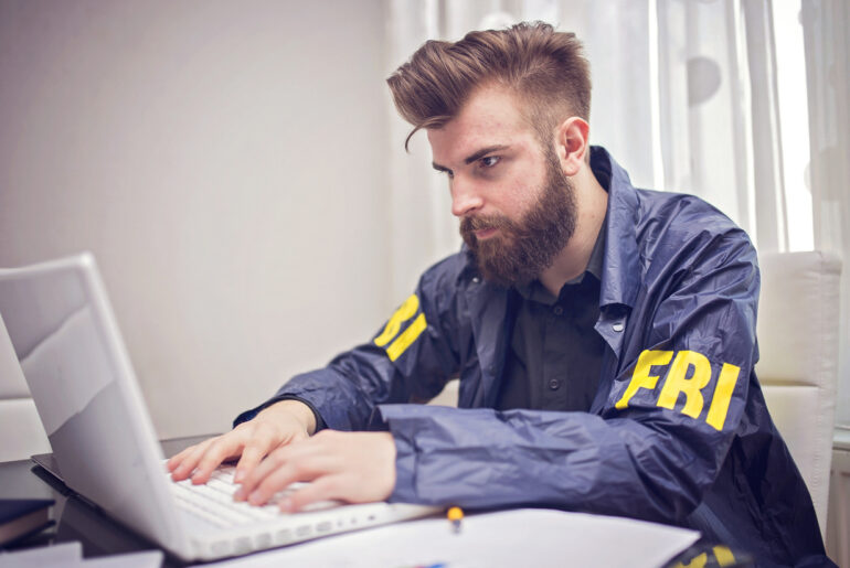 FBI student studying on a laptop for the FBI test