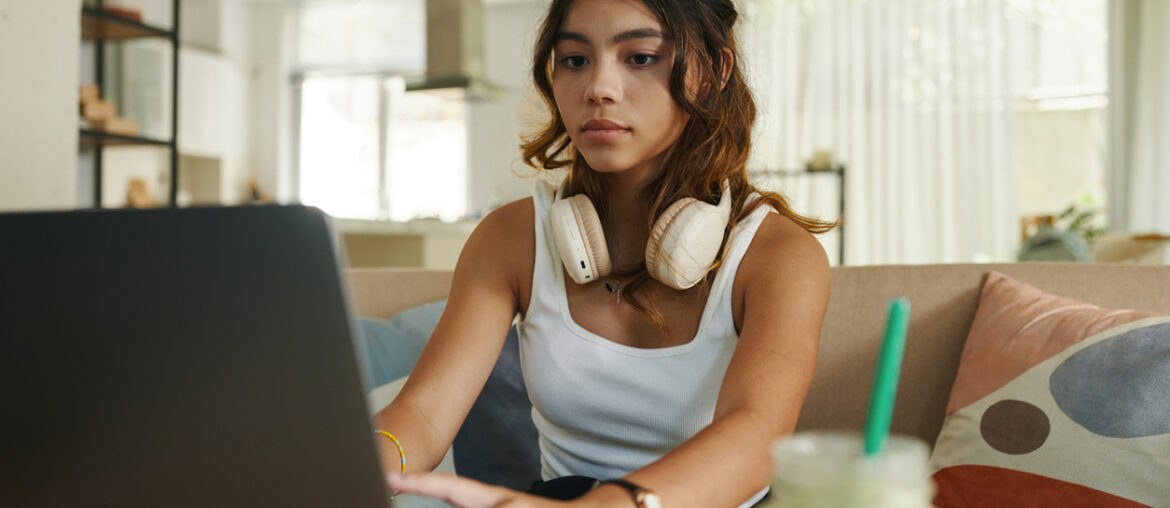 Teen studying for online testing with test prep online.