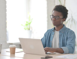 A student on a laptop realizing that they made a mistake and should've taken ACT Test Advice