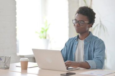 A student on a laptop realizing that they made a mistake and should've taken ACT Test Advice