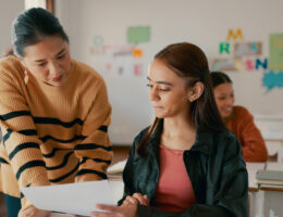 Teacher helping student raise their PSAT scores​ with Peterson's PSAT prep