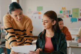 Teacher helping student raise their PSAT scores​ with Peterson's PSAT prep