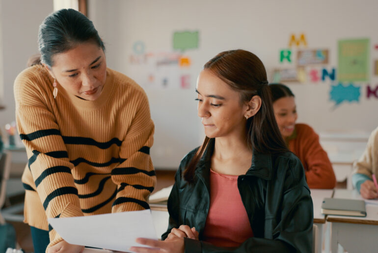 Teacher helping student raise their PSAT scores​ with Peterson's PSAT prep