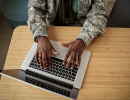 A student online deciding between AFOQT vs. ASTB-E tests to prepare for.