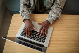 A student online deciding between AFOQT vs. ASTB-E tests to prepare for.