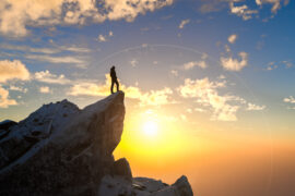 A student at the top of a vista, enjoying a life focused on growth mindset.