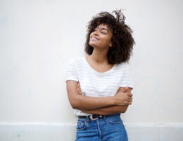Student looking upwards hopefully, deciding what leveling up to the best version of herself means to her while pursuing college and career readiness.
