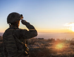 Soldier Saluting her dream ASVAB scores with a sunset knowing she worked hard on her ASVAB practice test mistakes.